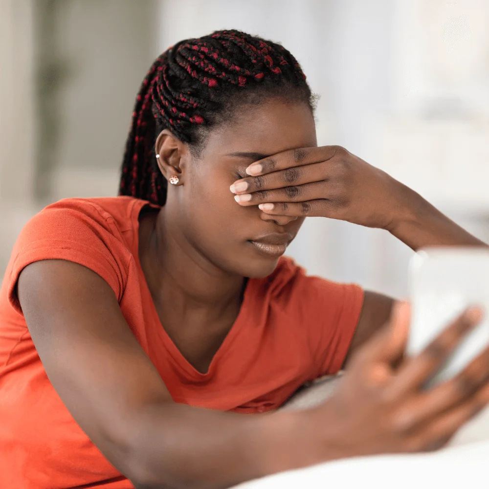 picture of a lady staring at her phone tired